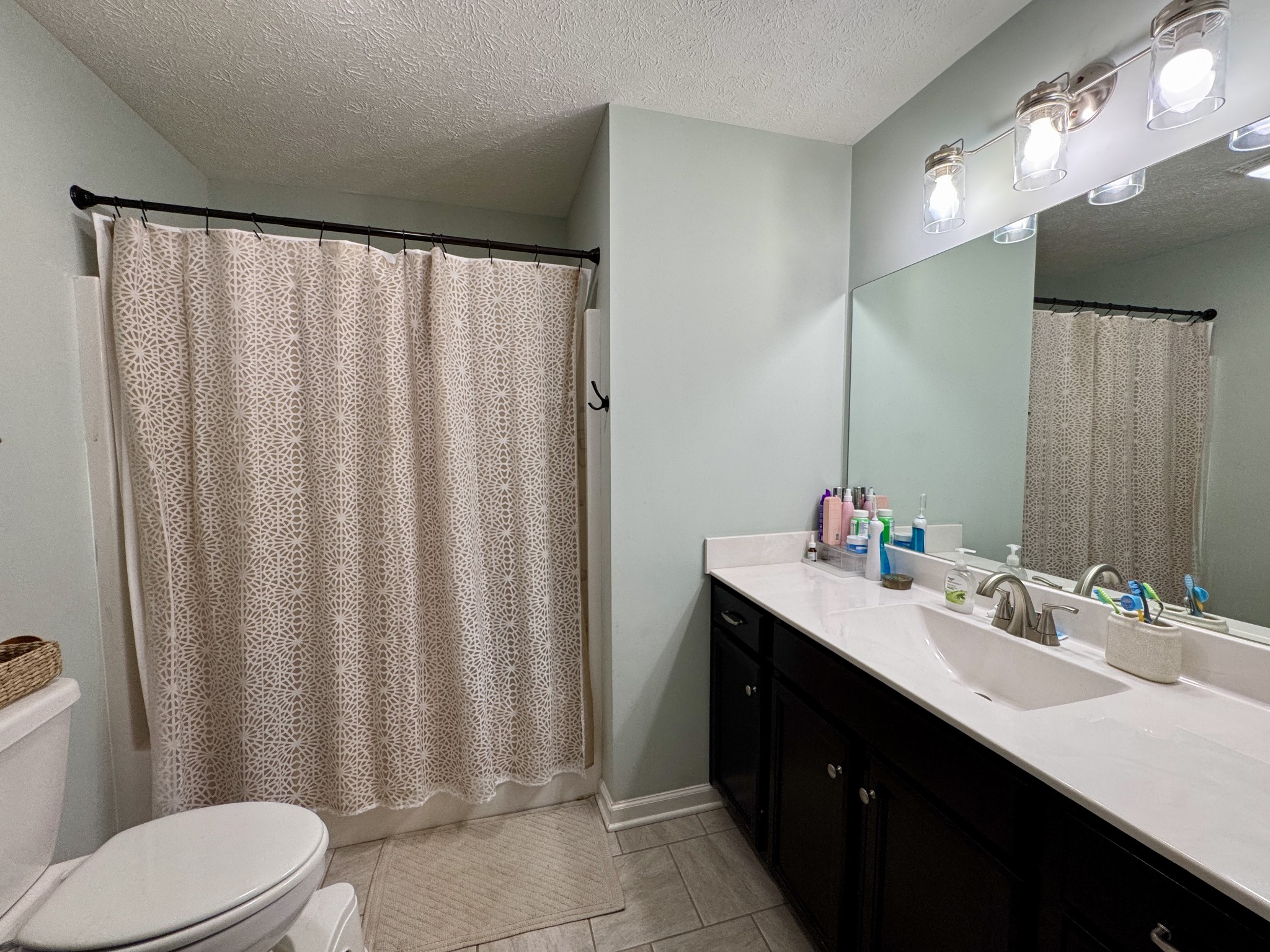 1119 Smiley Troutt Road Bethpage, TN 37022 - Photo 14 of 21 a bathroom with a double vanity sink toilet and a mirror