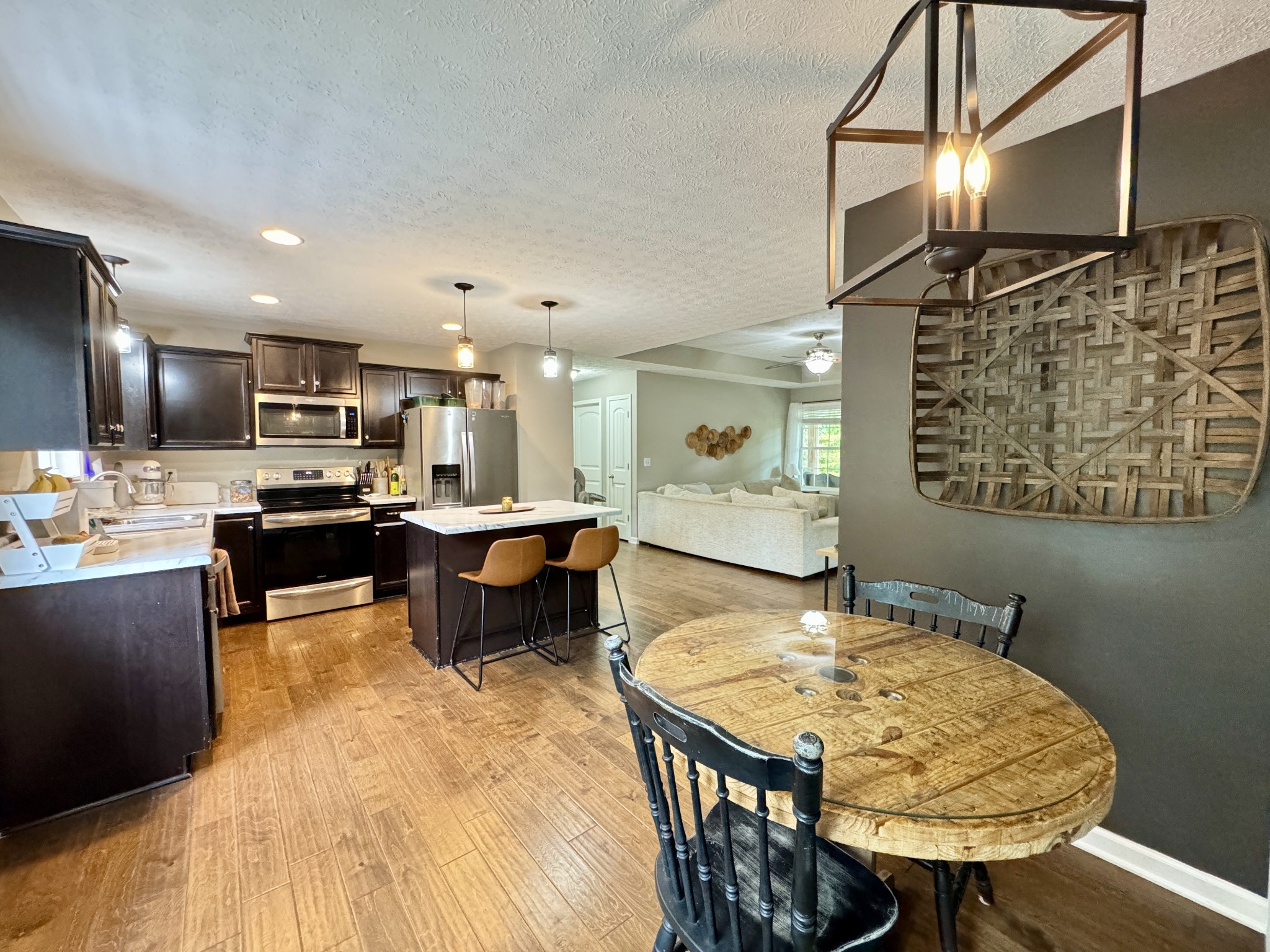 1119 Smiley Troutt Road Bethpage, TN 37022 - Photo 6 of 21 a living room with stainless steel appliances kitchen island a table and chairs in it