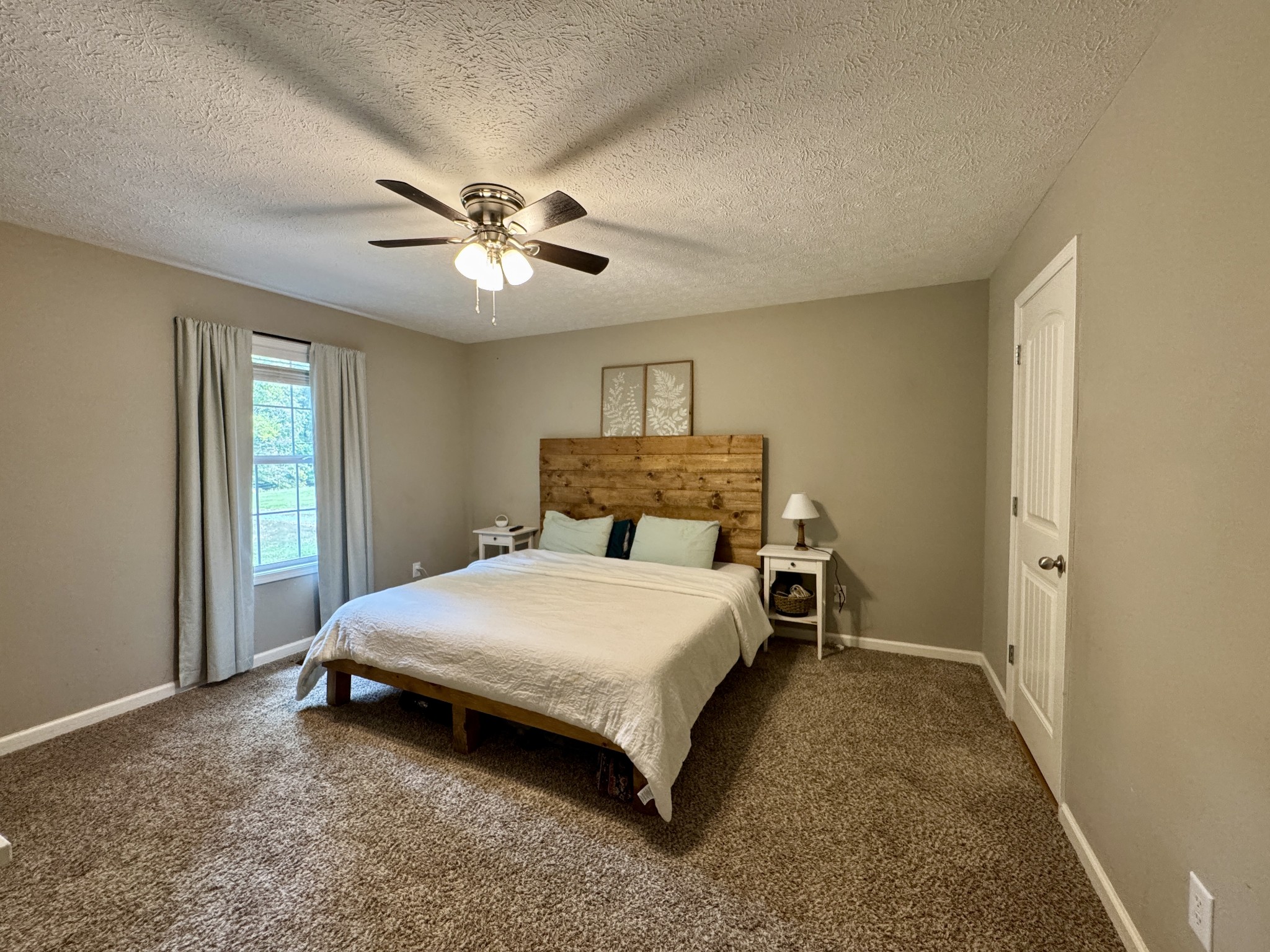 1119 Smiley Troutt Road Bethpage, TN 37022 - Photo 10 of 21 a bedroom with a bed and a chandelier