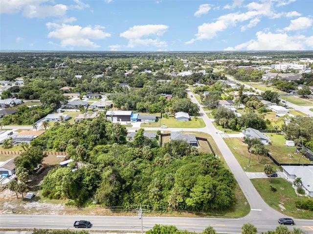 an aerial view of residential houses with city view