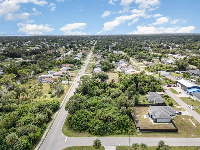 an aerial view of a residential houses with city view