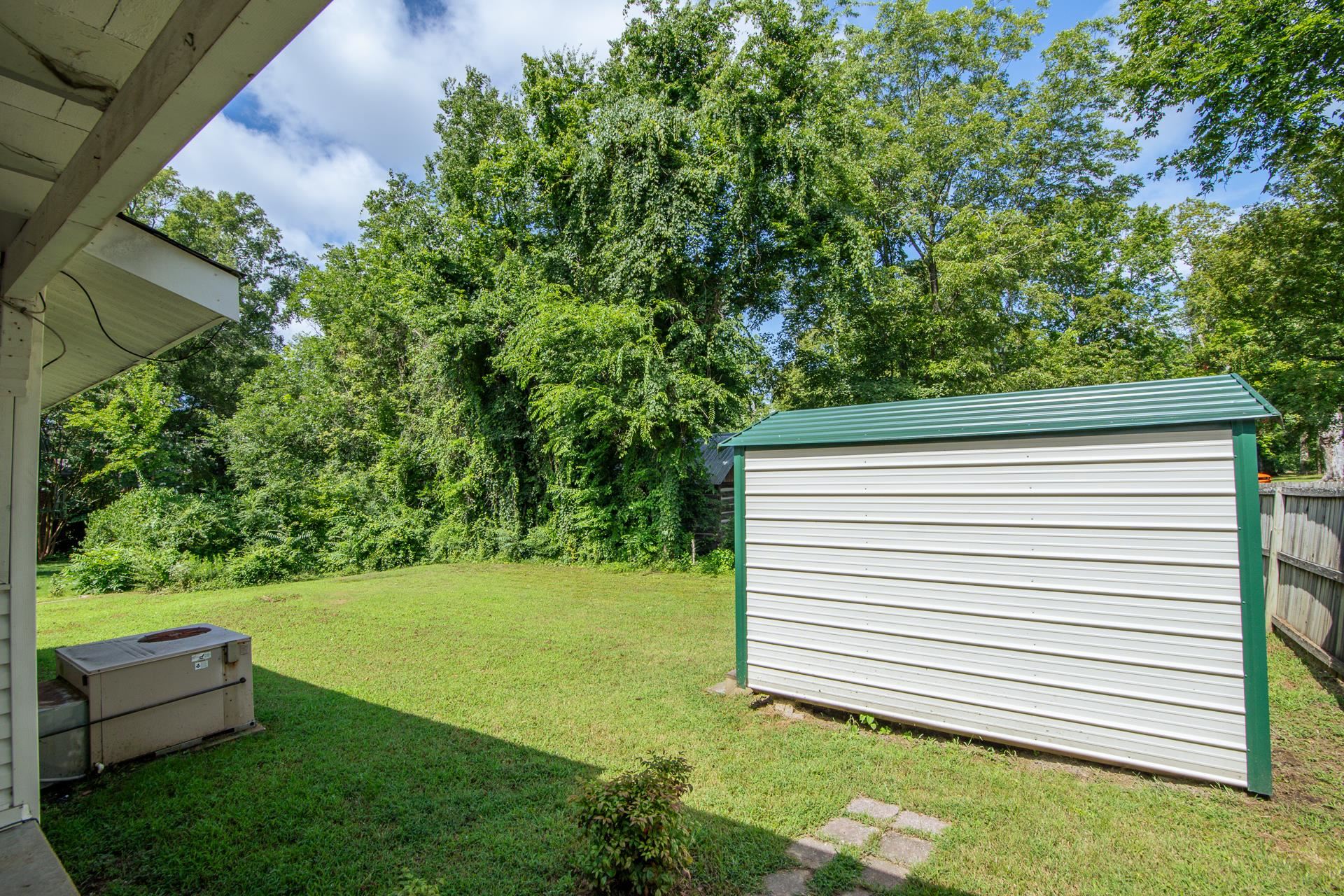 70 Pickwick Road Savannah, TN 38372 - Photo 25 of 31 View of green lawn featuring a storage unit