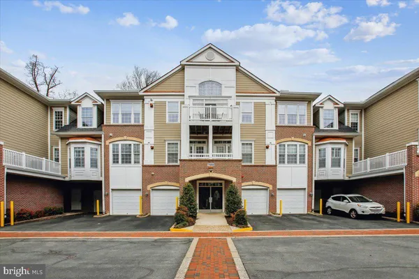 a front view of a residential apartment building with a yard