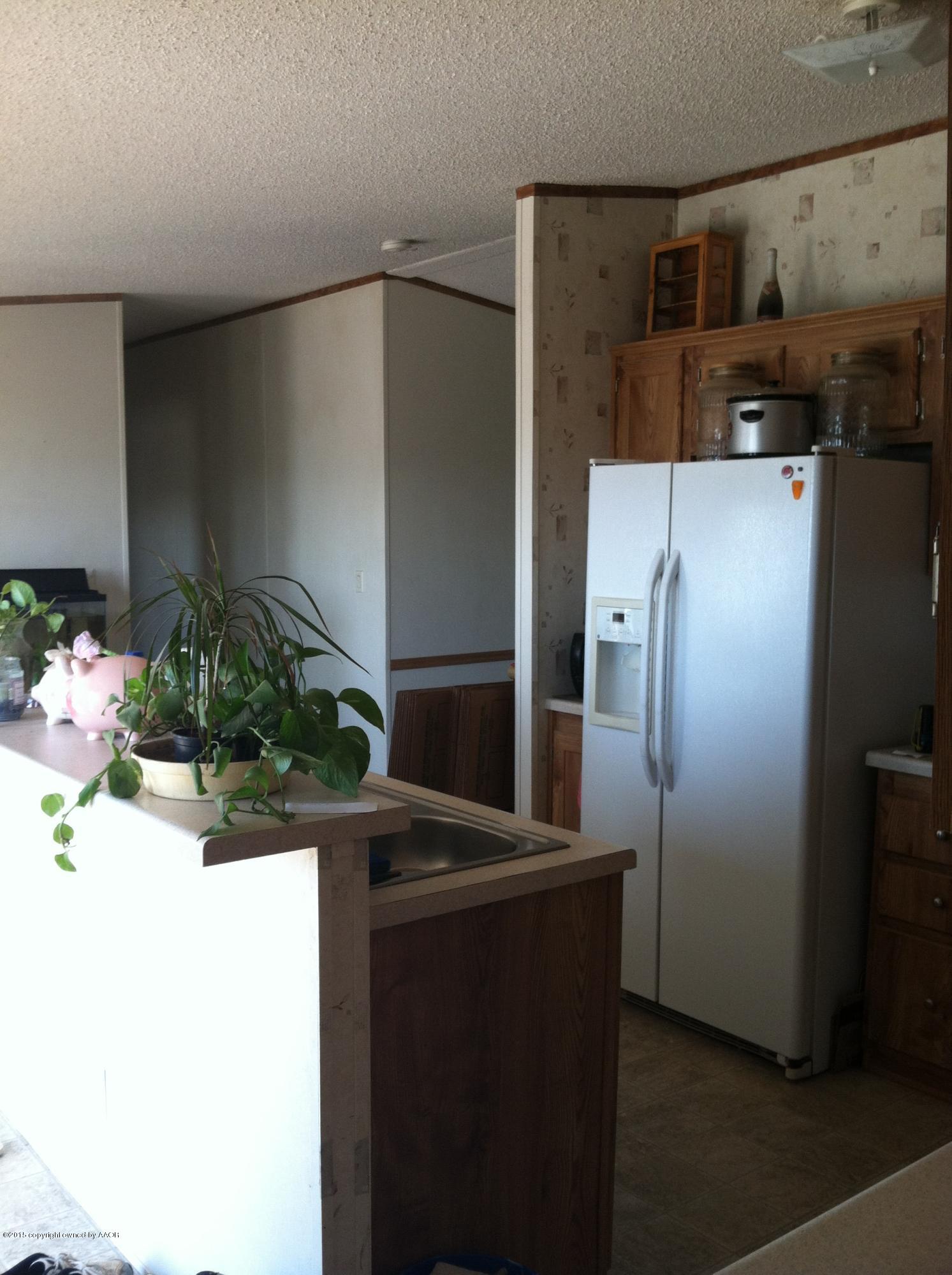 91 Chattanooga Road Amarillo, TX 79118 - Photo 27 of 28 a kitchen with a refrigerator and a counter top