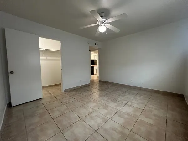 an empty room with staircase and white walls