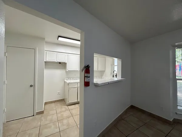 a kitchen with a refrigerator and cabinets