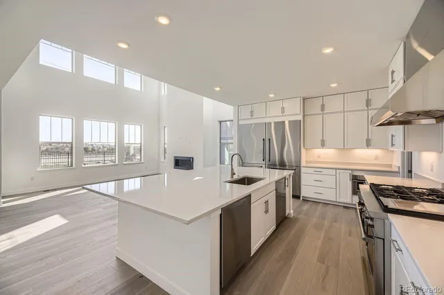 a kitchen with stainless steel appliances granite countertop a stove and a sink