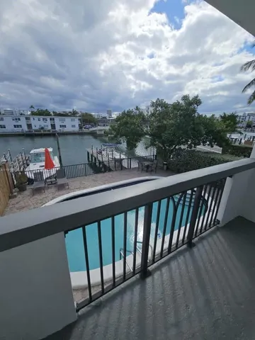 a balcony with outdoor seating and city view