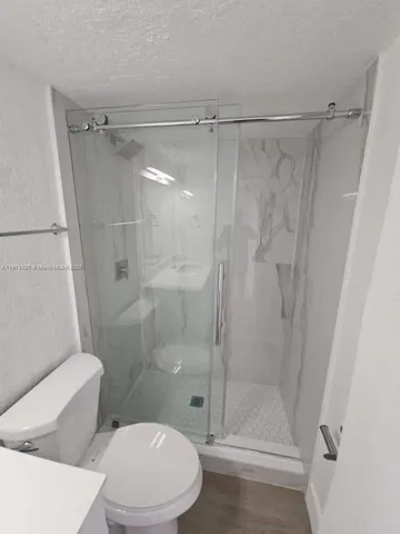 a bathroom with a shower and a toilet