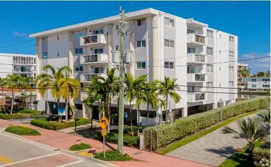 a living room with furniture and a book shelf