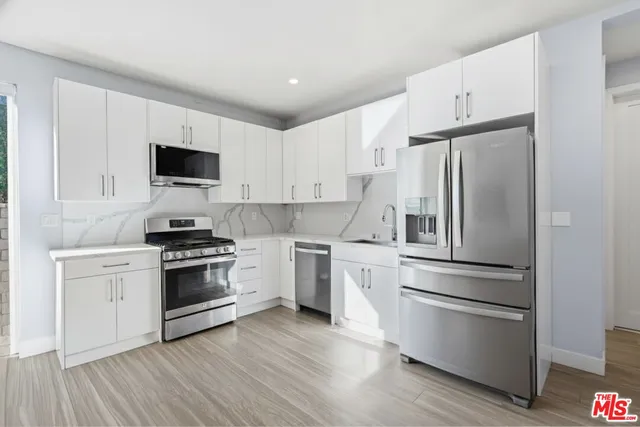 a kitchen with a refrigerator stove and sink