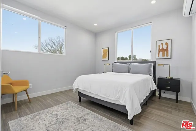 a bedroom with a bed and a painting on the wall