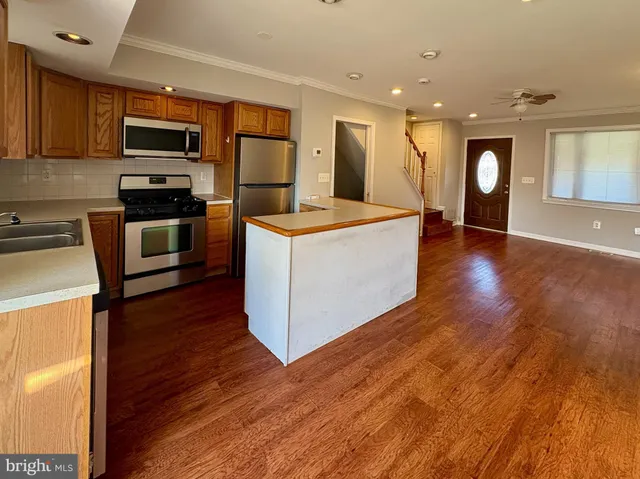 a kitchen with a sink and steel appliances