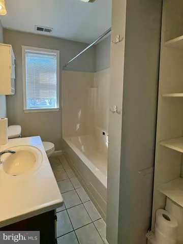 a bathroom with a bathtub and a sink