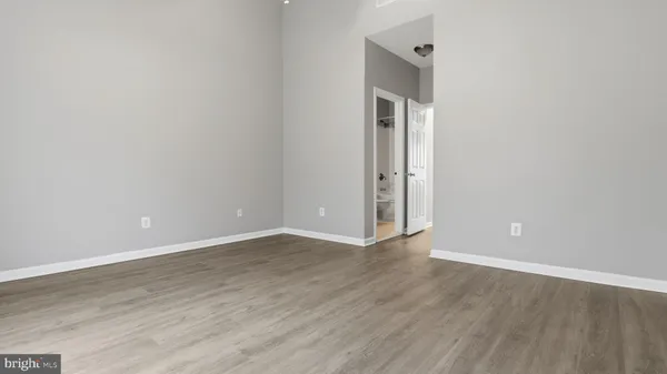 a bedroom with a bed and a potted plant