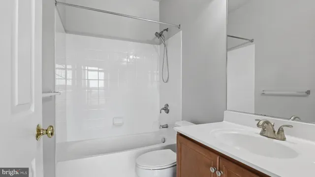 an empty room and wooden floor with a bathroom