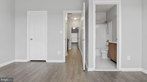 a spacious bedroom with a bed and a potted plant
