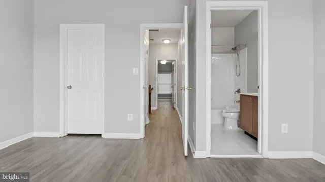 a spacious bedroom with a bed and a potted plant