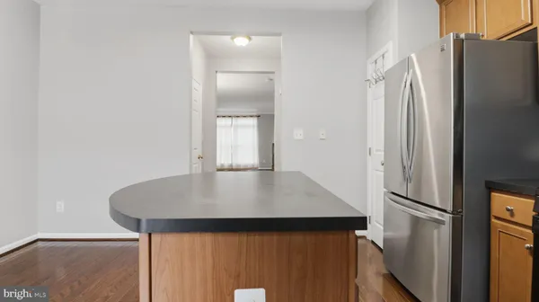 a kitchen with granite countertop wooden cabinets and stainless steel appliances