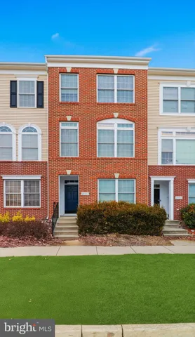 a front view of a residential apartment building with a yard