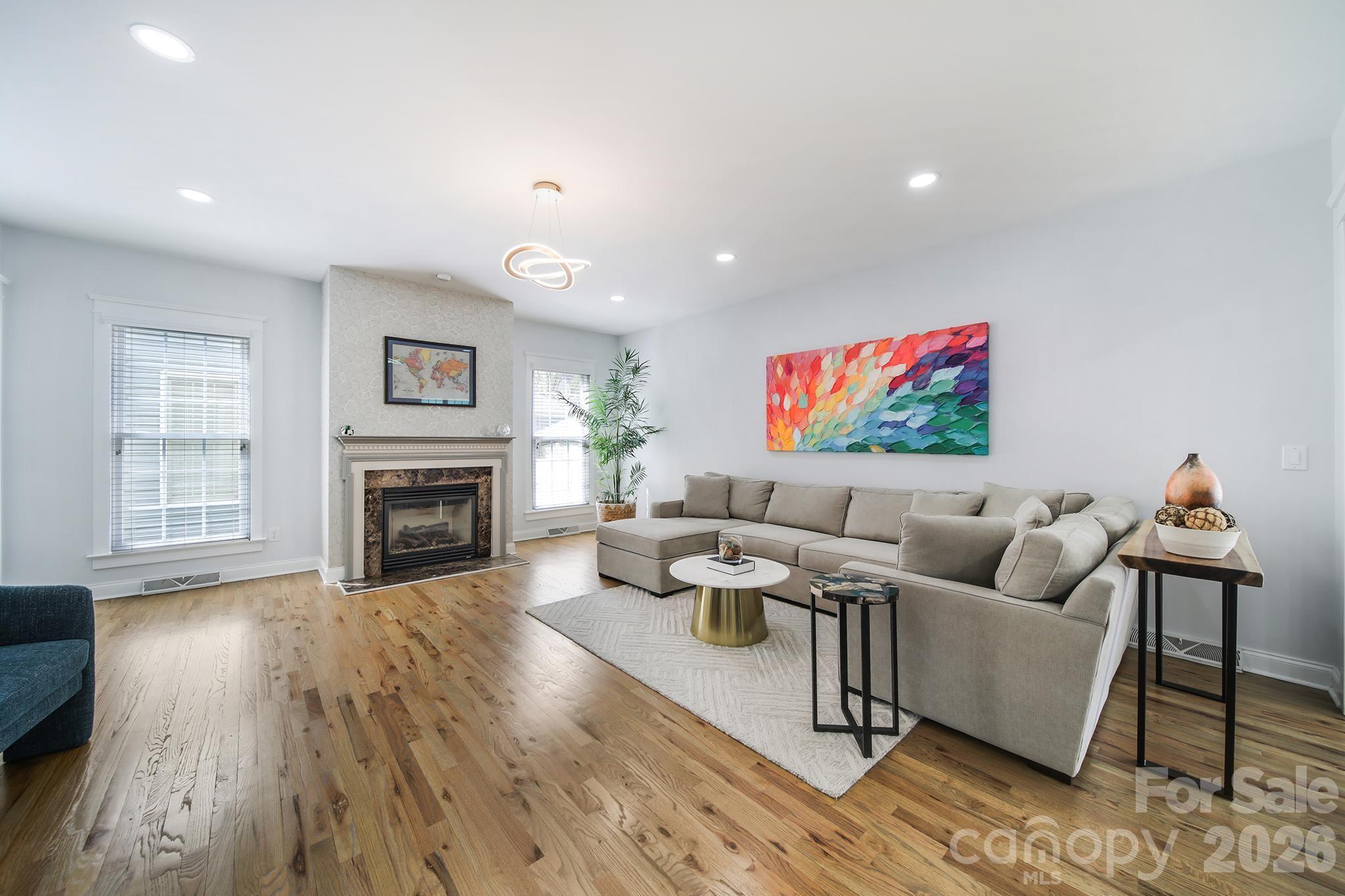 882 Promenade Walk Fort Mill, SC 29708 - Photo 15 of 48 a living room with fireplace furniture and a wooden floor