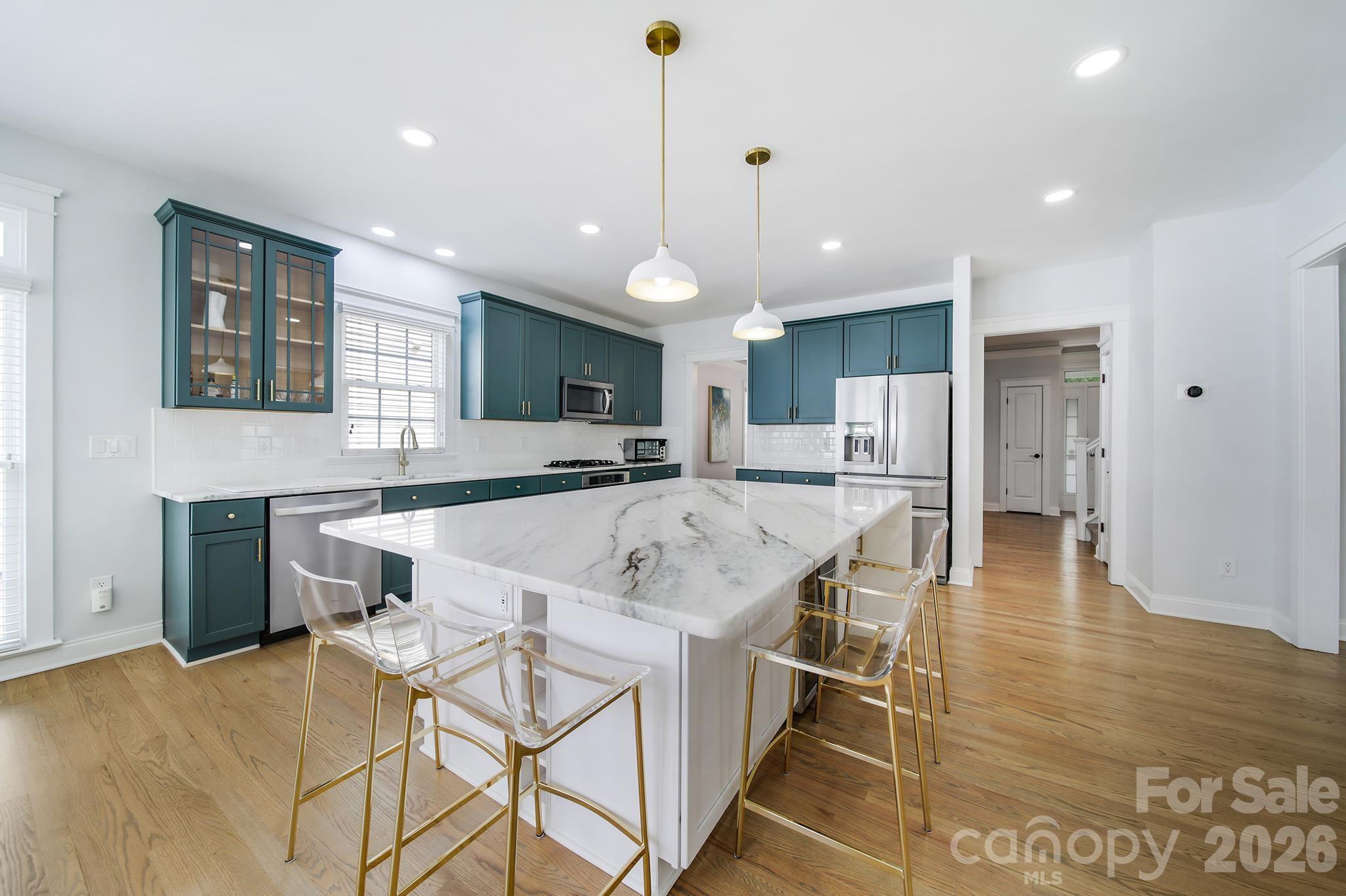 882 Promenade Walk Fort Mill, SC 29708 - Photo 8 of 48 a large kitchen with kitchen island a island a sink stainless steel appliances and cabinets