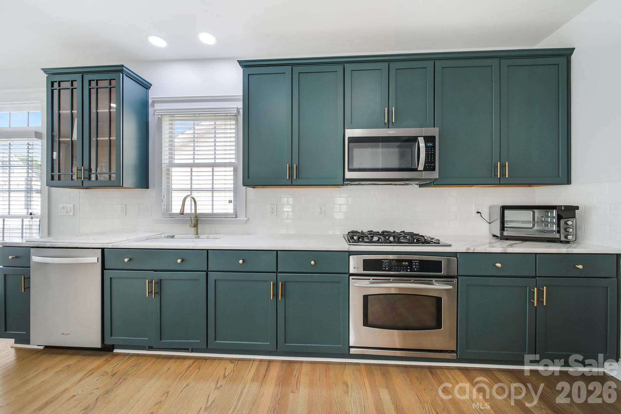 882 Promenade Walk Fort Mill, SC 29708 - Photo 10 of 48 a kitchen with stainless steel appliances granite countertop wooden cabinets and a stove top oven