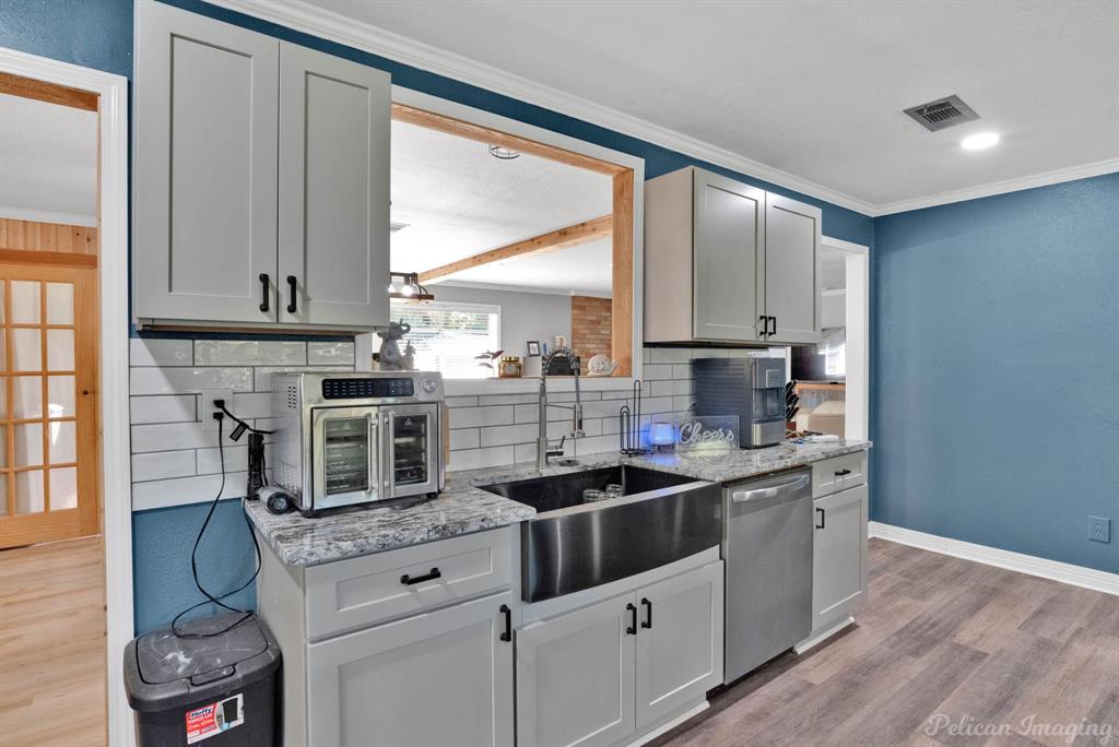 1100 Chipper Lane Keithville, LA 71047 - Photo 12 of 28 a kitchen with stainless steel appliances granite countertop a stove a sink and a microwave