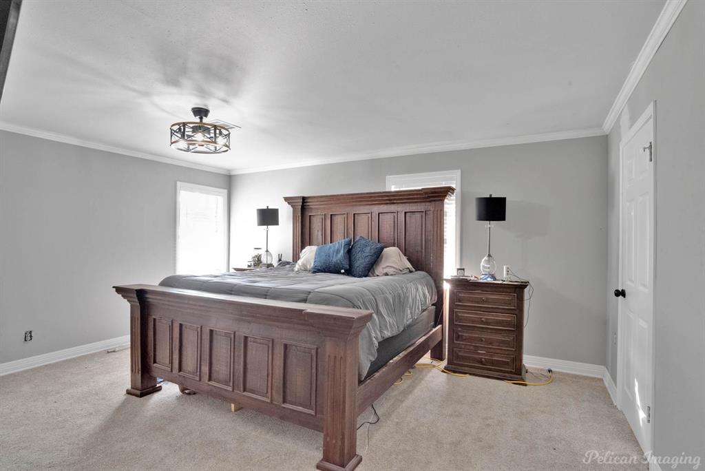 1100 Chipper Lane Keithville, LA 71047 - Photo 15 of 28 a bed room with a bed and a chandelier