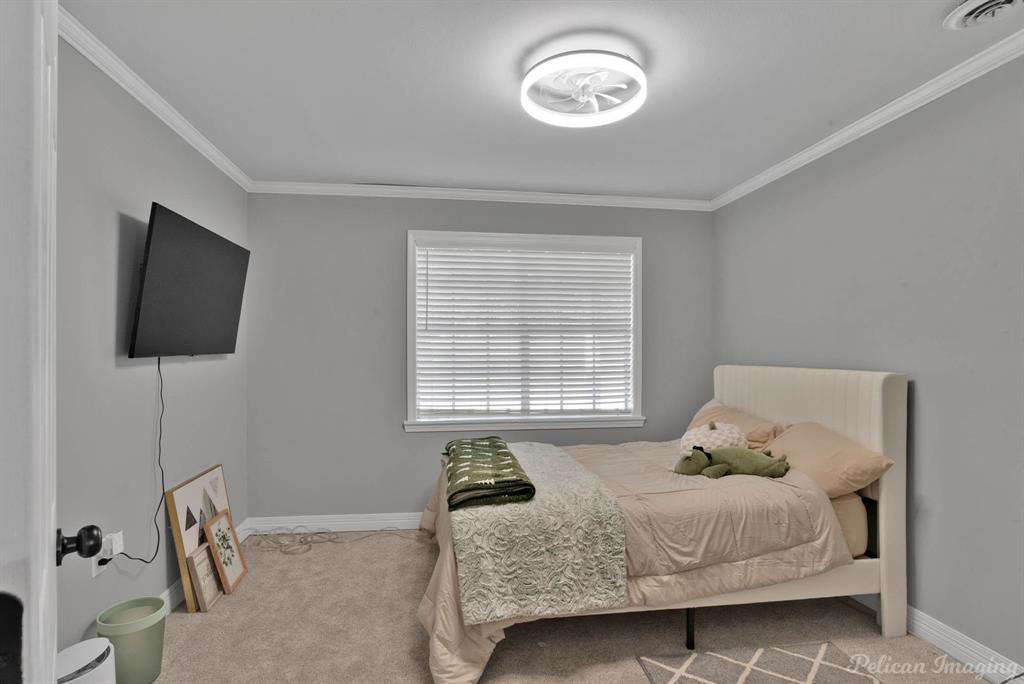 1100 Chipper Lane Keithville, LA 71047 - Photo 19 of 28 a bedroom with a bed and a flat screen tv