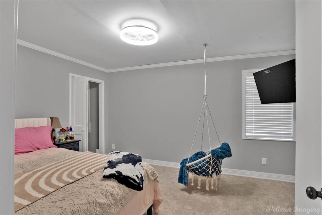 1100 Chipper Lane Keithville, LA 71047 - Photo 21 of 28 a bedroom with a bed and a tv