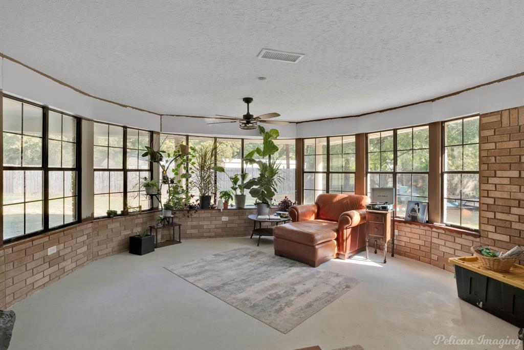 1100 Chipper Lane Keithville, LA 71047 - Photo 23 of 28 a living room with furniture and floor to ceiling windows