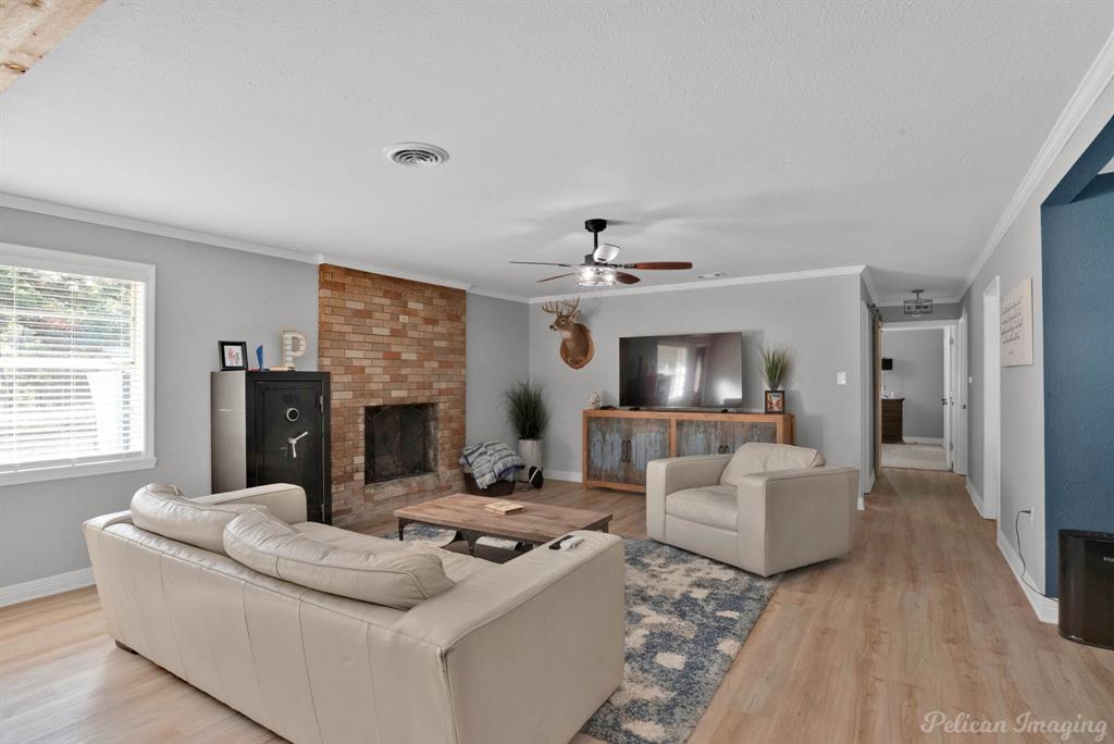 1100 Chipper Lane Keithville, LA 71047 - Photo 4 of 28 a living room with furniture and a fireplace