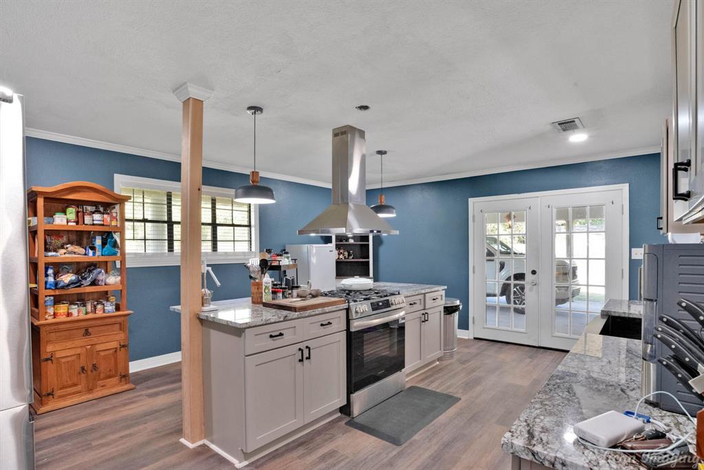 1100 Chipper Lane Keithville, LA 71047 - Photo 10 of 28 a kitchen with stainless steel appliances granite countertop a stove and a view of living room