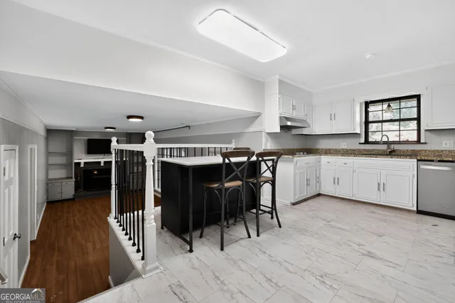 a kitchen with stainless steel appliances granite countertop a sink and cabinets