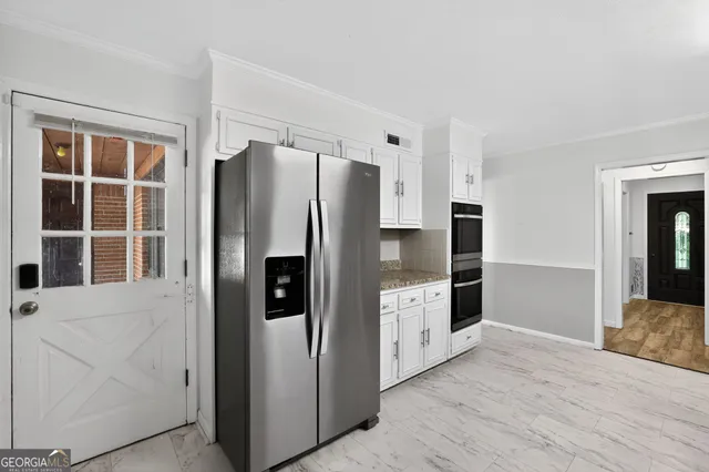 a kitchen with stainless steel appliances a refrigerator and a sink