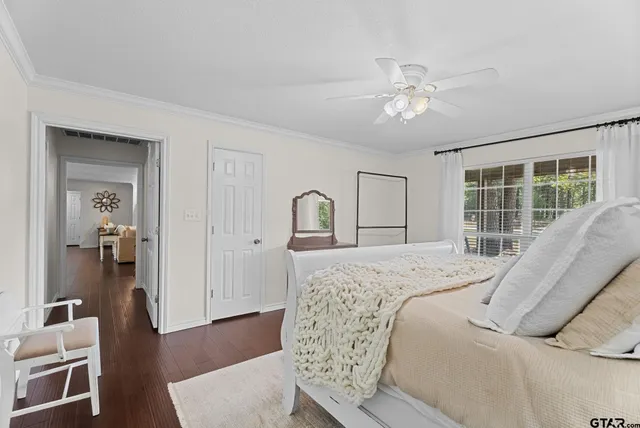 a bedroom with a bed and a large window