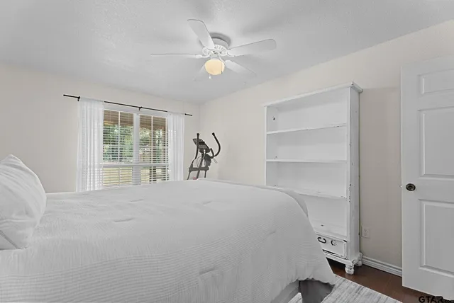 a bedroom with a large bed and a window