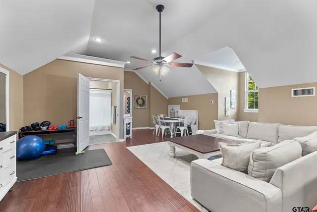 a living room with furniture and wooden floor