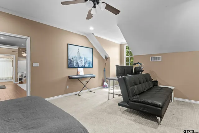 a living room with furniture and a ceiling fan