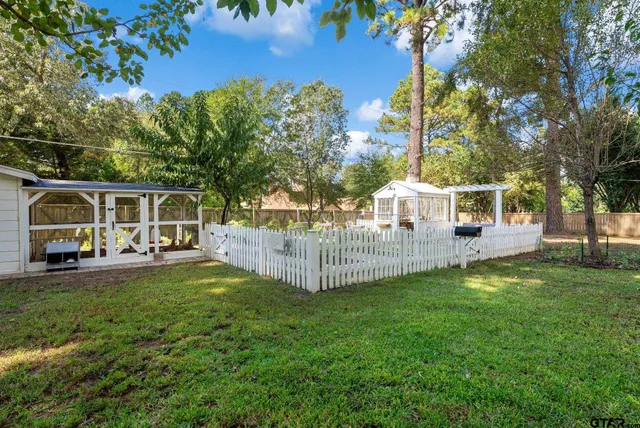 a view of a house with a yard and sitting area