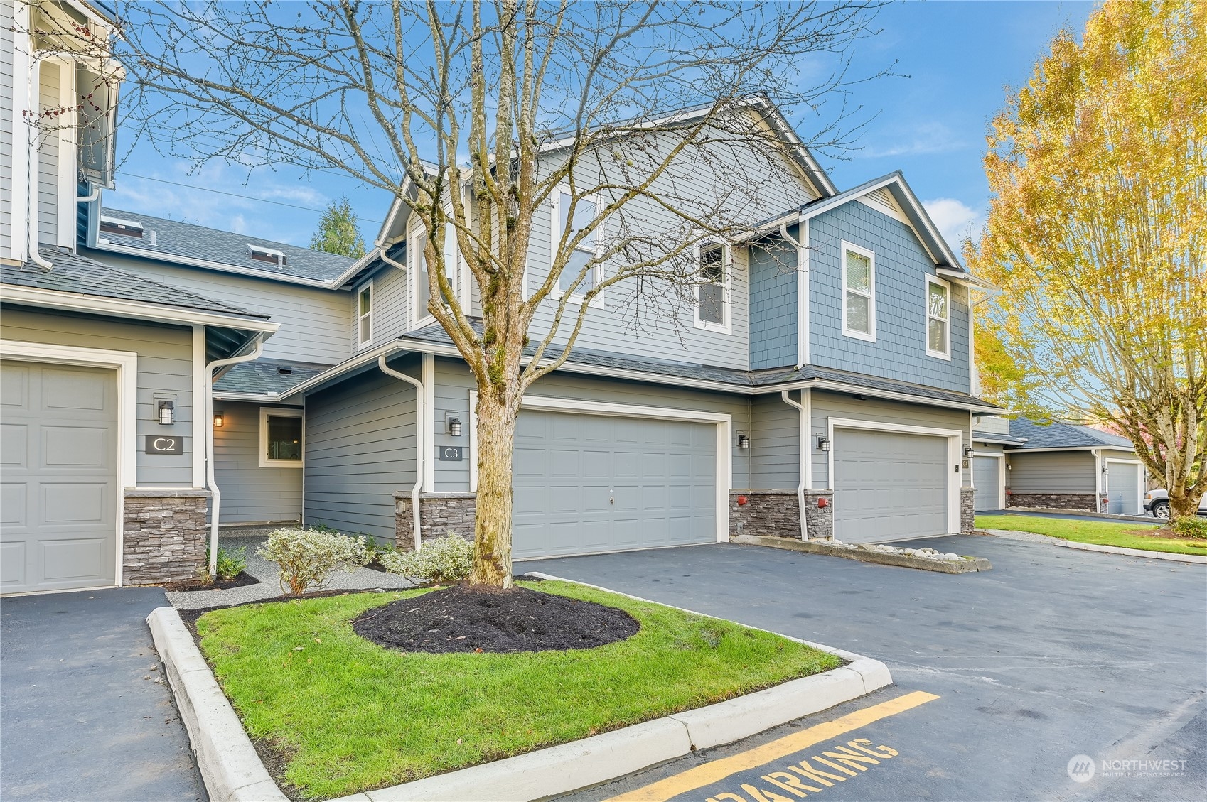 2201 192nd Street Southeast, Unit C3 Bothell, WA 98012 - Photo 1 of 26 a front view of a house with a yard and garage