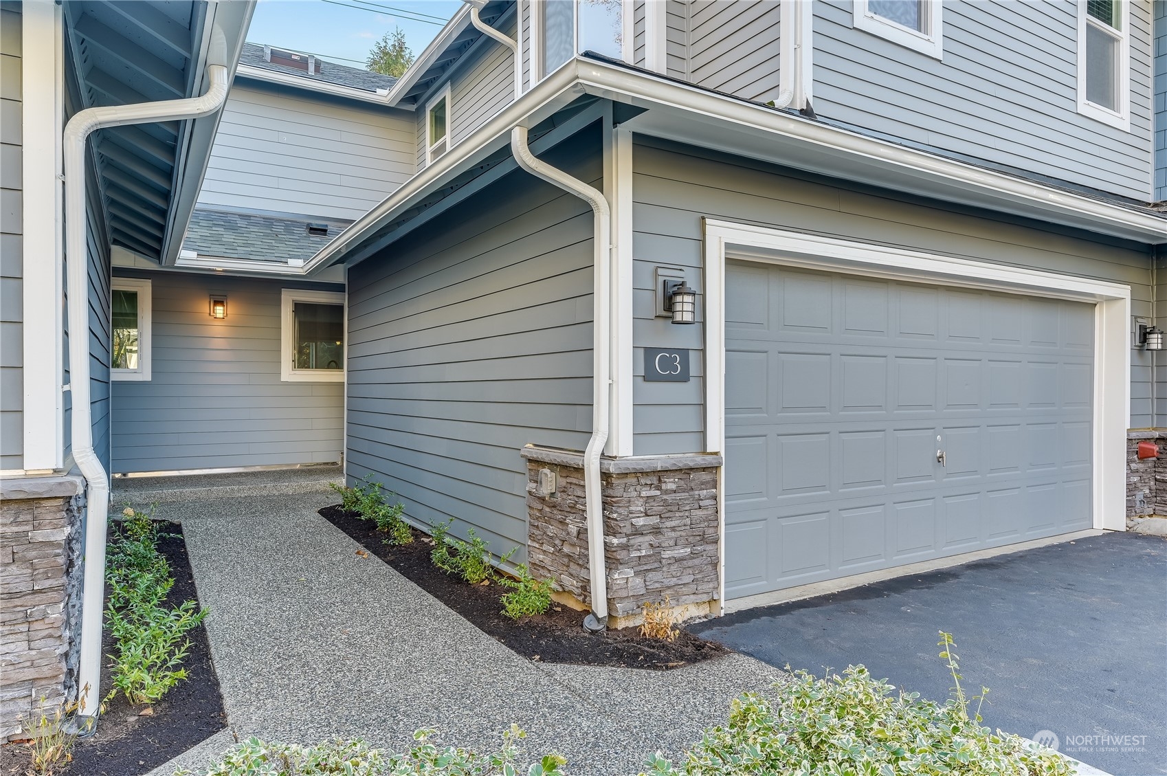 2201 192nd Street Southeast, Unit C3 Bothell, WA 98012 - Photo 3 of 26 a front view of a house with a garage