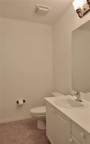 a en suite bathroom with a granite countertop sink and a mirror