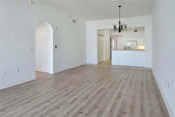 a bedroom with a bed and a couch with windows