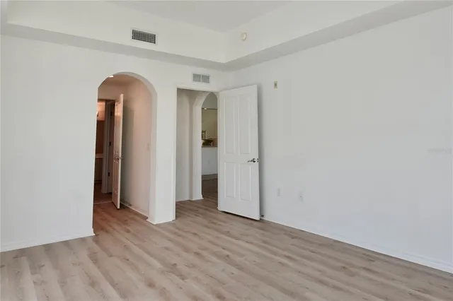 a view of a patio with table and chairs with wooden floor and fence