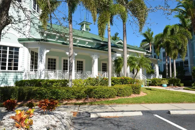 a view of a large building with a big yard and plants