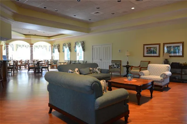 a living room with furniture and a chandelier