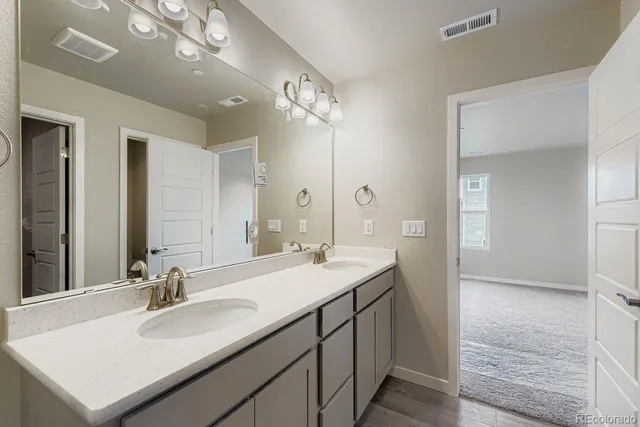 a bathroom with a sink double vanity and a mirror