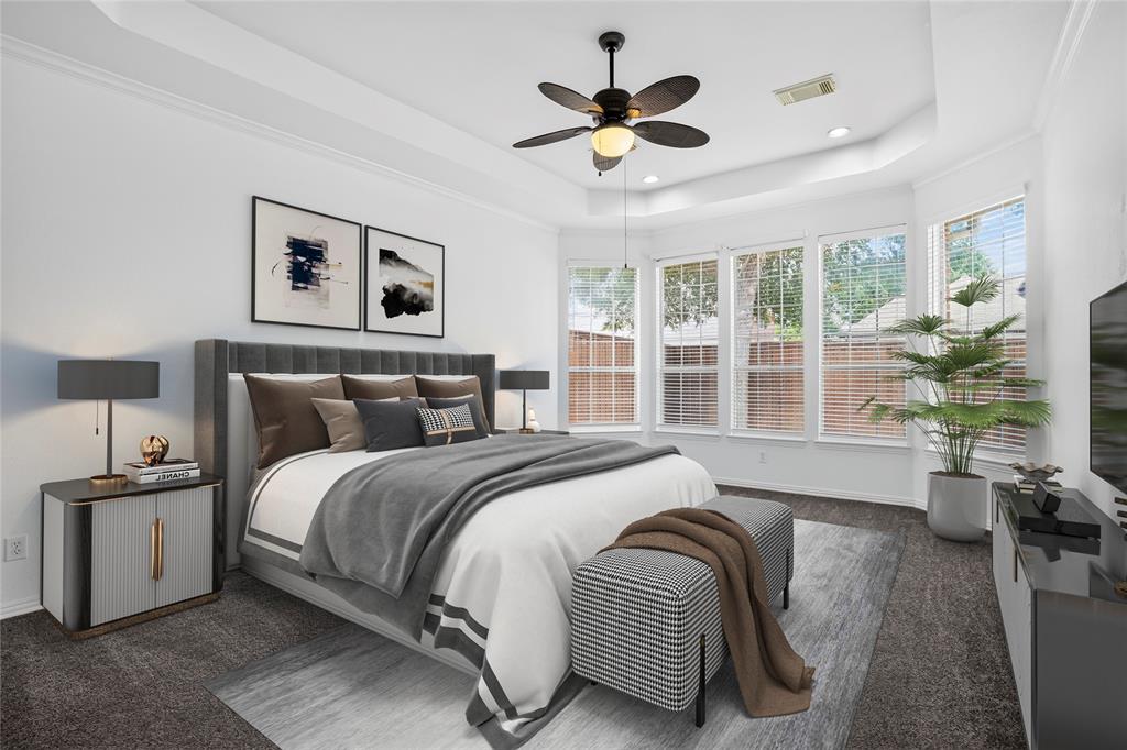 111 Ripplewood Coppell, TX 75019 - Photo 17 of 34 Spacious 1st Floor PRIMARY bedroom featuring a tray ceiling, ceiling fan, and multiple windows with blinds